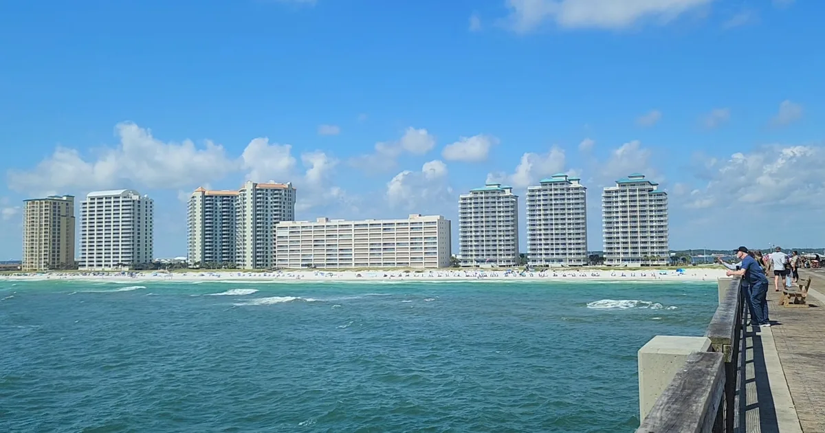 The beach and condo towers of Navarre Beach, Florida, seen from the fishing pier on a sunny day